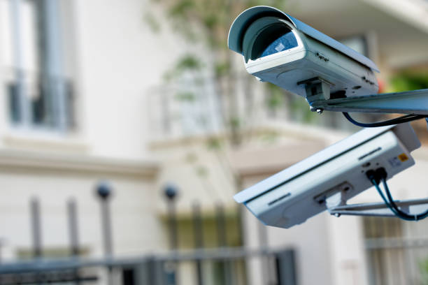 istock security CCTV camera or surveillance system with private builiding on blurry background 1093512128