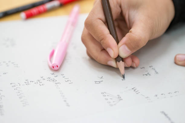 istock Students using pen writing information on white answer paper in high school, Asian exams room, Tests or examination is assessment intended to measure knowledge, skill, aptitude, Education Concept 1093514550