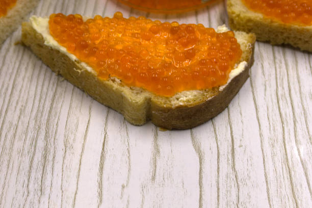istock Red caviar salmon roe on a slice of bread and butter . 1093514690
