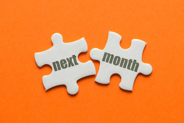 istock The word Next Month on two matching puzzle on orange background 1093515388