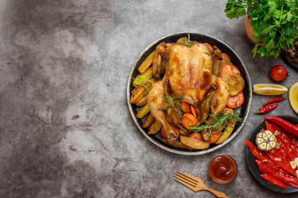 istock Roasted chicken, potatoes and vegetables in plate on grey background. Top view. With copy space 1093515570