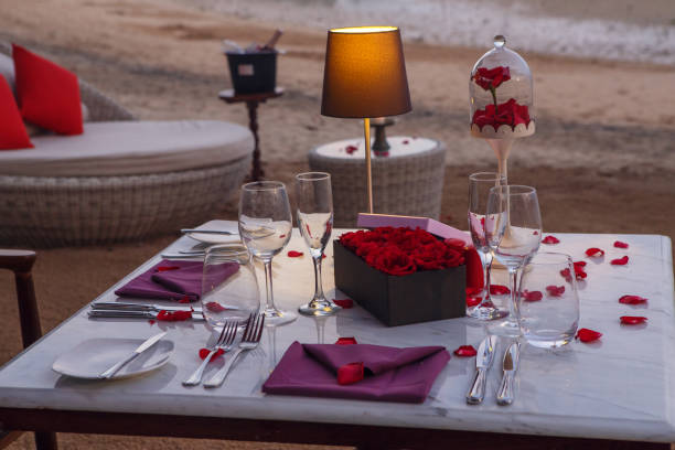 istock Romantic beach evening dinner during sunset: candles, champagne. Valentines day concept 1093515780