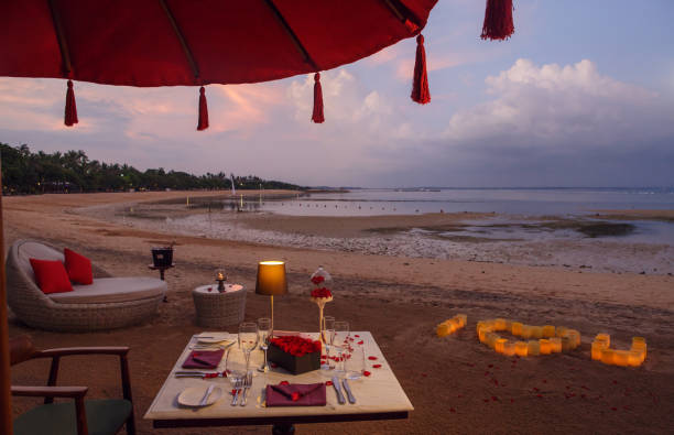 istock Romantic beach evening dinner during sunset: candles, champagne. Valentines day concept 1093516962