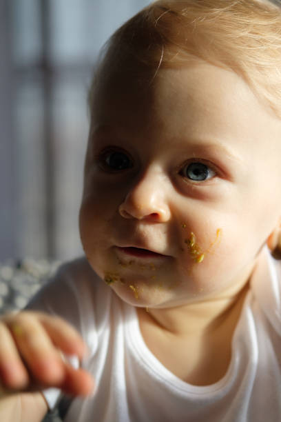 istock Feeding a baby in a highchair 1093517626
