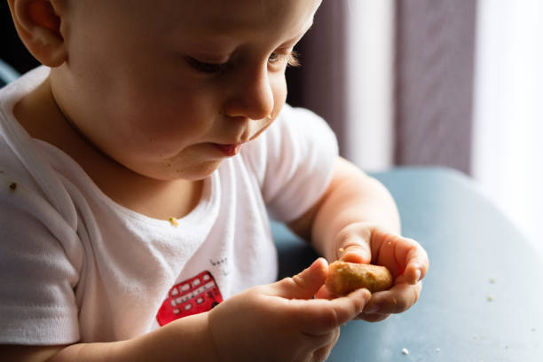 istock Feeding a baby in a highchair 1093518330