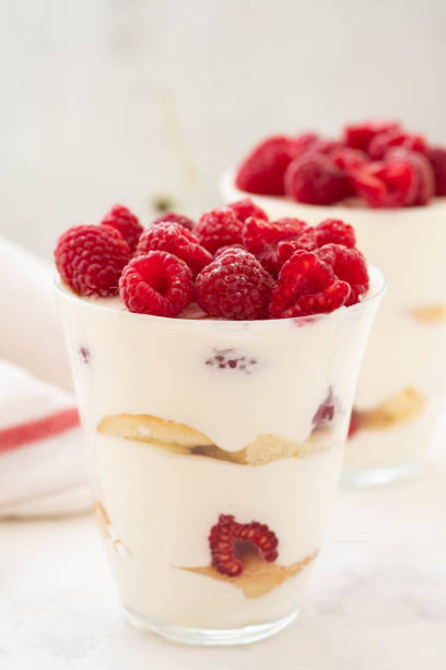 Raspberry dessert, cheesecake, trifle, mouse in a glass on a white background.