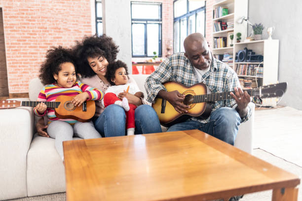 istock Grandfather playing guitar at home 1093525830