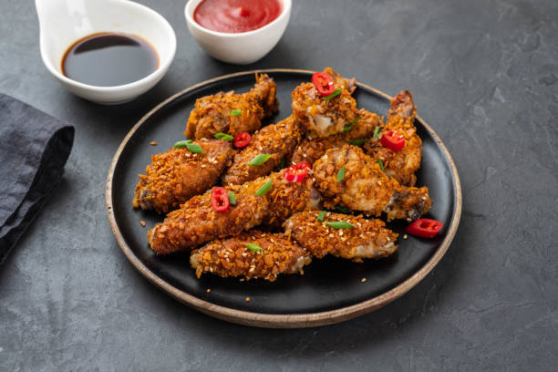 istock Chicken nuggets with sauce and pepper on a dark background. Copy space. 1093526746