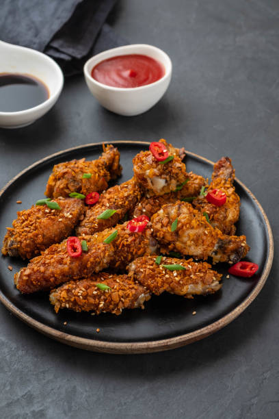 istock Chicken nuggets with sauce and pepper on a dark background. Copy space. 1093526774