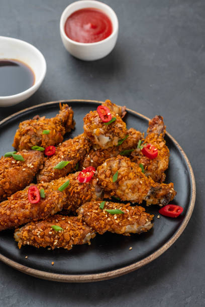 istock Chicken nuggets with sauce and pepper on a dark background. Copy space. 1093526930