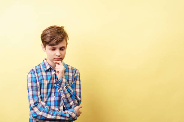 istock pondering pensive boy thinking of something 1093531950