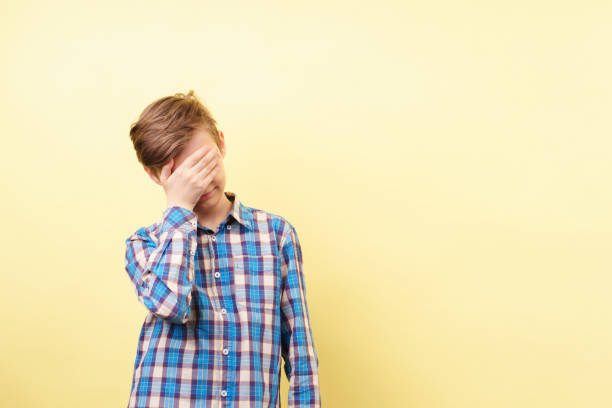 istock facepalm, desperate boy covering face with hand 1093531968