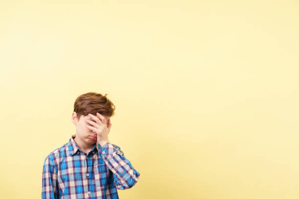 istock facepalm, frustrated boy covering face with hand 1093531972