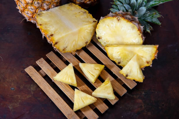 istock pineapple on the wooden texture background 1093535020