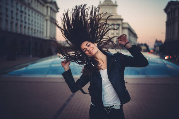 istock Young woman dancing on music 1093535204