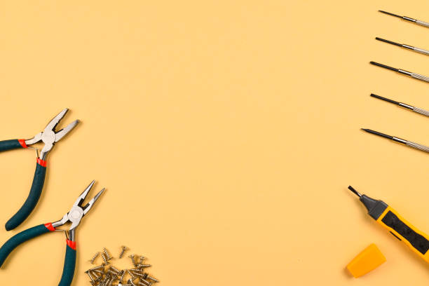 istock Screwdrivers and pliers on orange background 1093537596