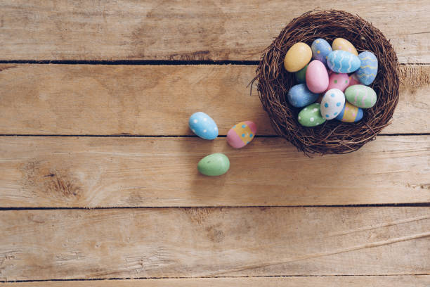 istock Colorful Easter egg and nest on wooden table background with copy space. 1093544120