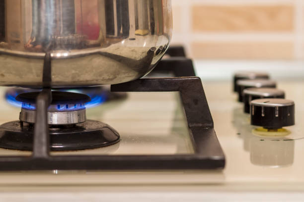 istock Metal cooking pot standing on kitchen stove with flame. 1093548884