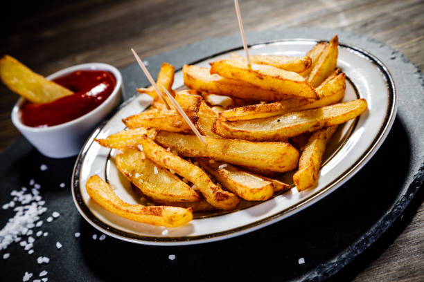 istock French fries on wooden background 1093549184