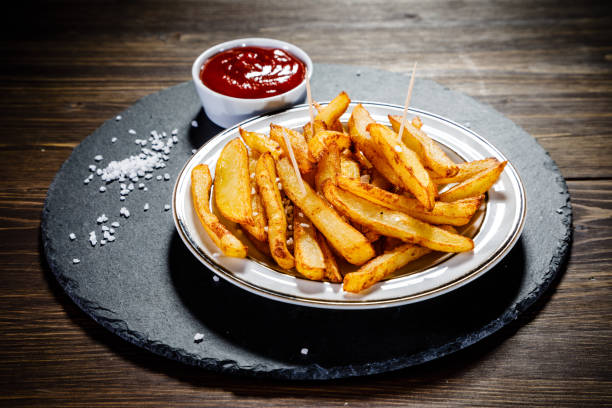 istock French fries on wooden background 1093551216
