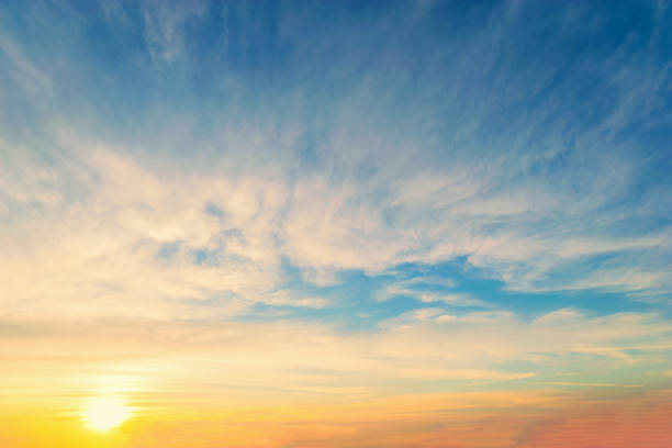 istock Sky blue and orange light of the sun through the clouds in the sky 1093553024