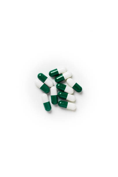 istock white-green pill capsules isolated on white background, medical concept, copy space, top view 1093554400