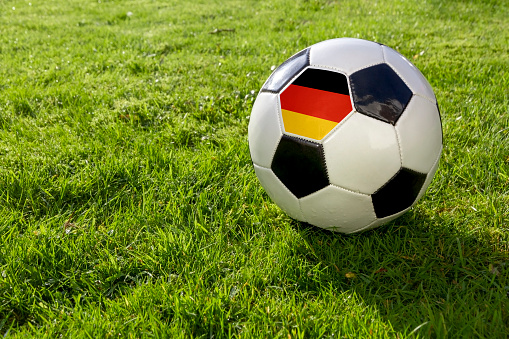 Football on a grass pitch with German Flag