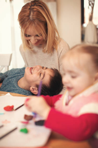 istock Family at home doing homework together 1093557178