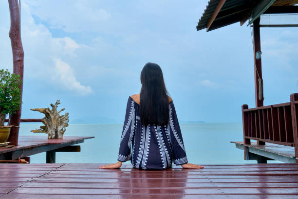 Beautiful woman posing - sitting back view, enjoying and relaxing