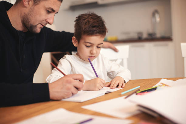 istock Family at home doing homework together 1093558912