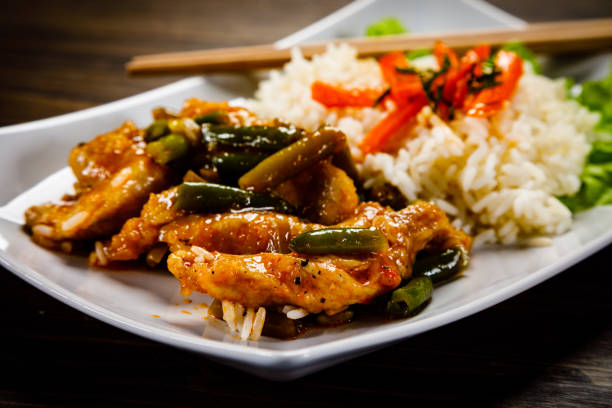 istock White rice with meat and vegetables on wooden background 1093558946
