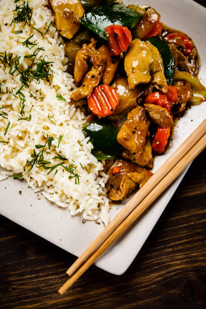 istock White rice with meat and vegetables on wooden background 1093559366