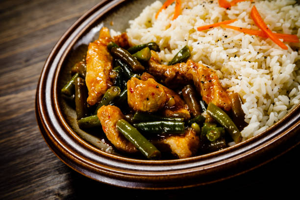 istock White rice with meat and vegetables on wooden background 1093561446