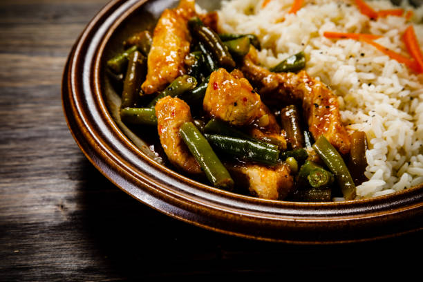 istock White rice with meat and vegetables on wooden background 1093561508
