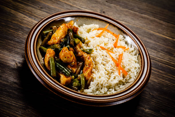 istock White rice with meat and vegetables on wooden background 1093561756