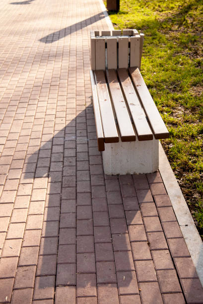 istock A beautiful brown empty bench stands in the Park on summer 1093562664