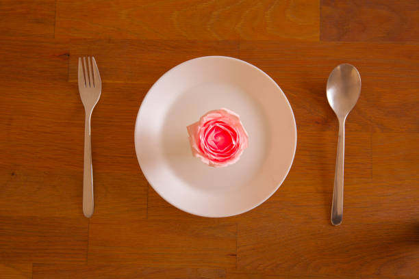 Pink roses placed on a white food plate on special days, love is the food of life.
