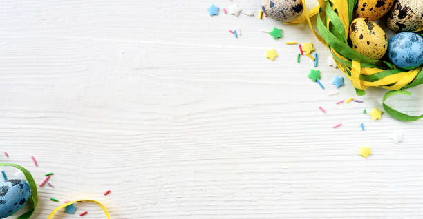 istock Easter eggs with decorations on white wooden background 1093573276