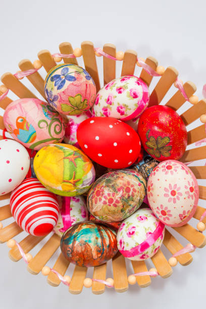 istock Colorful decorated and painted Easter eggs in wooden basket isolated on white background. Easter holiday concept. 1093574866