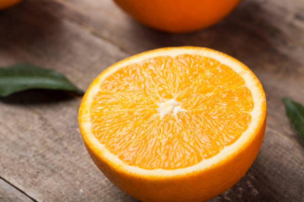 istock Closeup of orange with sliced orange on table 1093575080