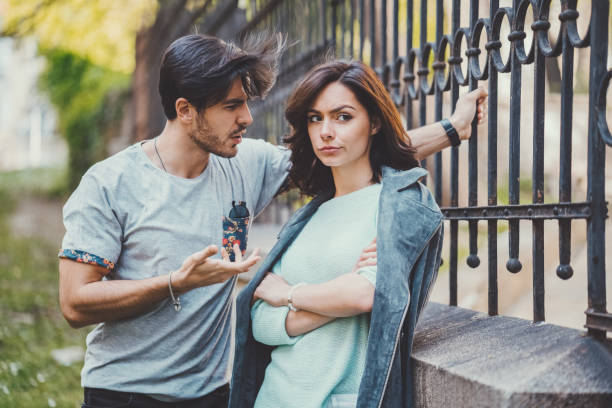 Couple discussing their relationship Unhappy couple outside talking about problems irritation stock pictures, royalty-free photos & images