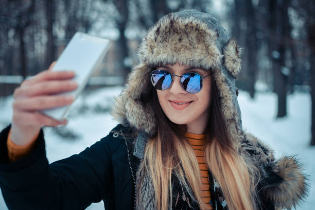 istock Beautiful woman portrait make snow selfie 1093578302