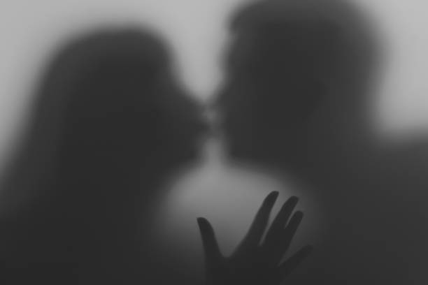 istock Silhouettes of two people in love. 1093581920