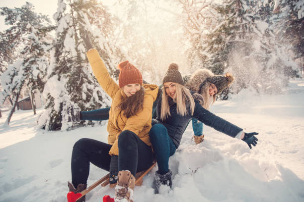 The three best friends enjoy the snow and winter games. stock photo
