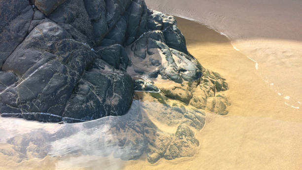 huge stones on the sandy shore, rocks and sand