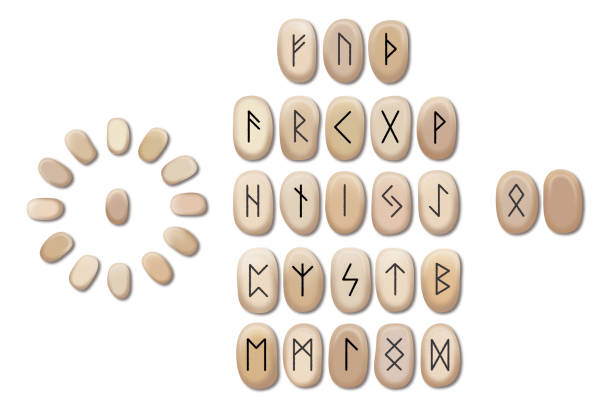 woman's hands teaching rune stones with black symbols for fortune telling on a wooden table