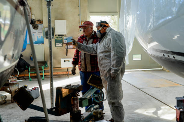 istock Two senior man working together maintaining sailing yacht 1093587872