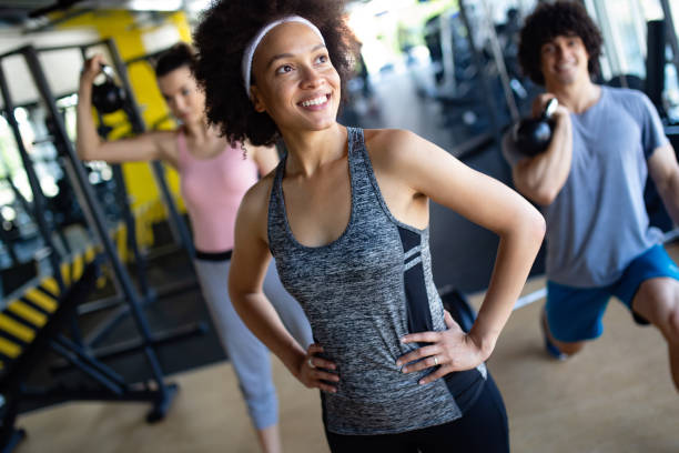 istock Group of sportive people in a gym training 1093588302