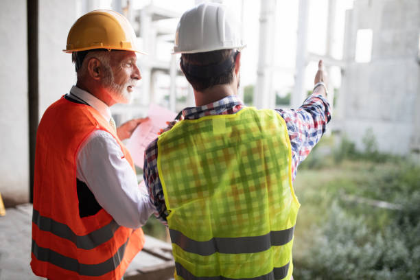 istock Team of architects and engineer in group on construciton site check documents and business workflow 1093588736