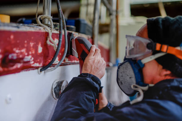 istock Man using grinding machine, maintenance of sailing yacht in boathouse 1093590766
